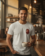 Man holding a coffee cup in a cozy cafe setting