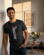 Man wearing a black t-shirt with 'Be Consistent' text in a living room.