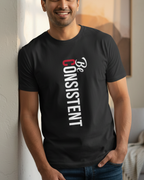 Man wearing a black t-shirt with 'Be Consistent' text in a living room