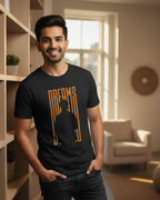 Man wearing a black t-shirt with 'DREAMS' design in a living room setting.