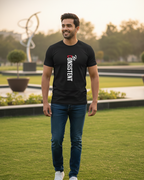 Man wearing a black t-shirt with 'The Consistent' text in an outdoor setting