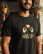 Man wearing a black t-shirt with a graphic design in a cozy indoor setting