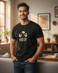 Man wearing a black t-shirt with a graphic design in a living room.