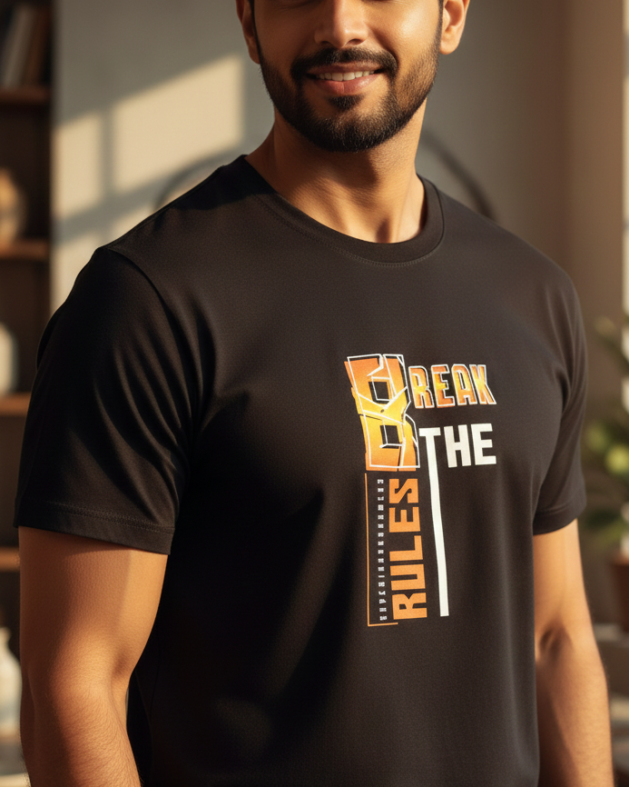 Man wearing a black t-shirt with a motivational quote in a home setting