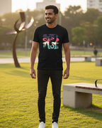 Man wearing a black t-shirt with colorful design in an outdoor setting