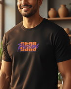 Man wearing a black t-shirt with colorful text in a room with plants and shelves.