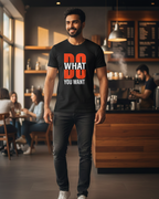 Man wearing a black t-shirt with motivational text in a coffee shop.