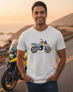 Man wearing a t-shirt with a motorcycle graphic on a road at sunset