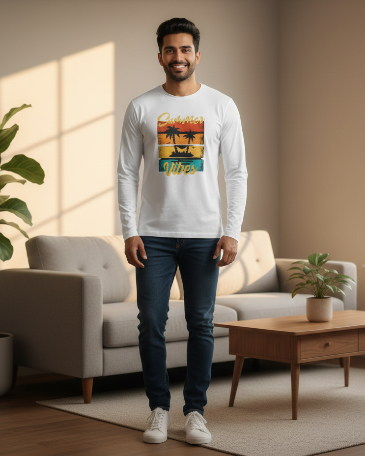 Man wearing a white long-sleeve shirt with a colorful graphic design in a living room.