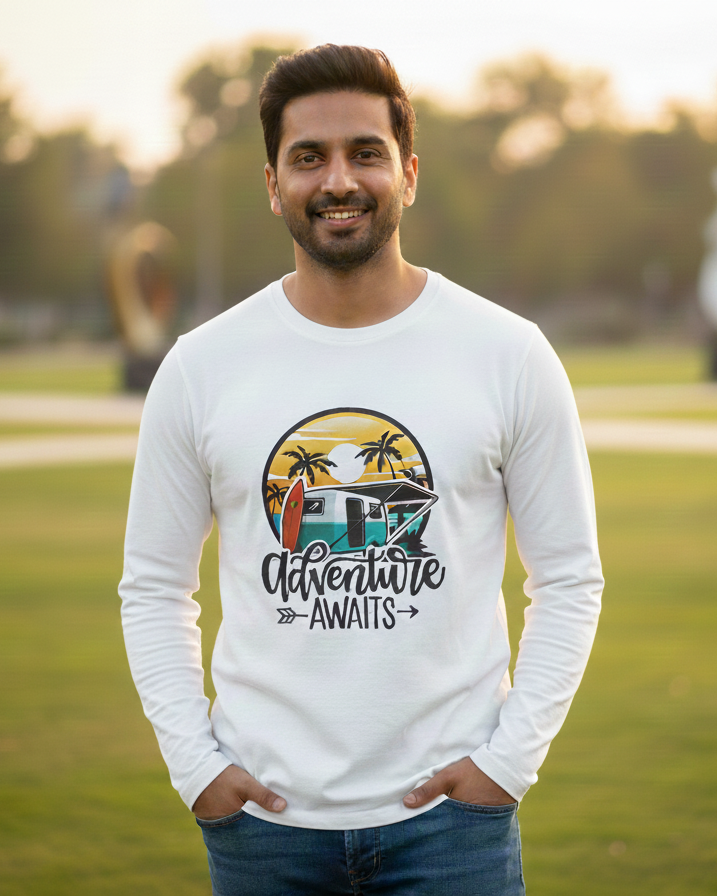 Man wearing a white sweatshirt with a graphic design and text, standing in a park.