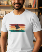 Man wearing a white t-shirt with a colorful graphic design in a room with shelves and plants.