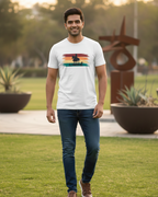 Man wearing a white t-shirt with a colorful graphic design outdoors.