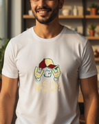 Man wearing a white t-shirt with a graphic design in a room with shelves and plants.