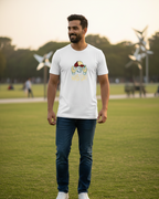 Man wearing a white t-shirt with a graphic design on a grassy field