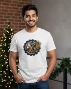 Man wearing a white t-shirt with a logo, standing in front of a decorated Christmas tree.