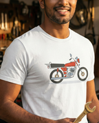 Man wearing a white t-shirt with a motorcycle graphic in a workshop