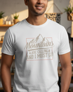 Man wearing a white t-shirt with a mountain design and text in a casual setting.