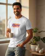 Man wearing a white t-shirt with colorful text in a bright room.
