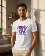 Man wearing a white t-shirt with purple text in a living room.