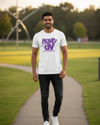 Man wearing a white t-shirt with purple text on a path in a park