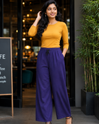 A Women standing outside the cafe  wearing a mustard yellow crew  neck t-shirt and tacao purple palazzo pant