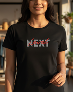 Person wearing a black t-shirt with 'NEXT' printed on it in a casual setting.