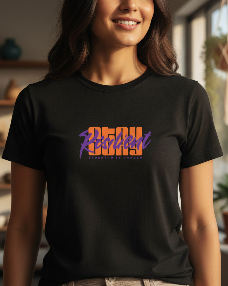 Person wearing a black t-shirt with colorful text in a home setting