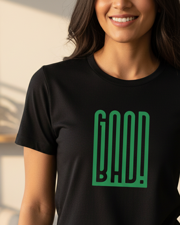 Person wearing a black t-shirt with green text in a living room setting