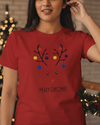 Person wearing a red t-shirt with a Christmas design in a festive setting