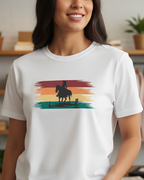 Person wearing a white t-shirt with a graphic design of a person on horseback against a rainbow background.