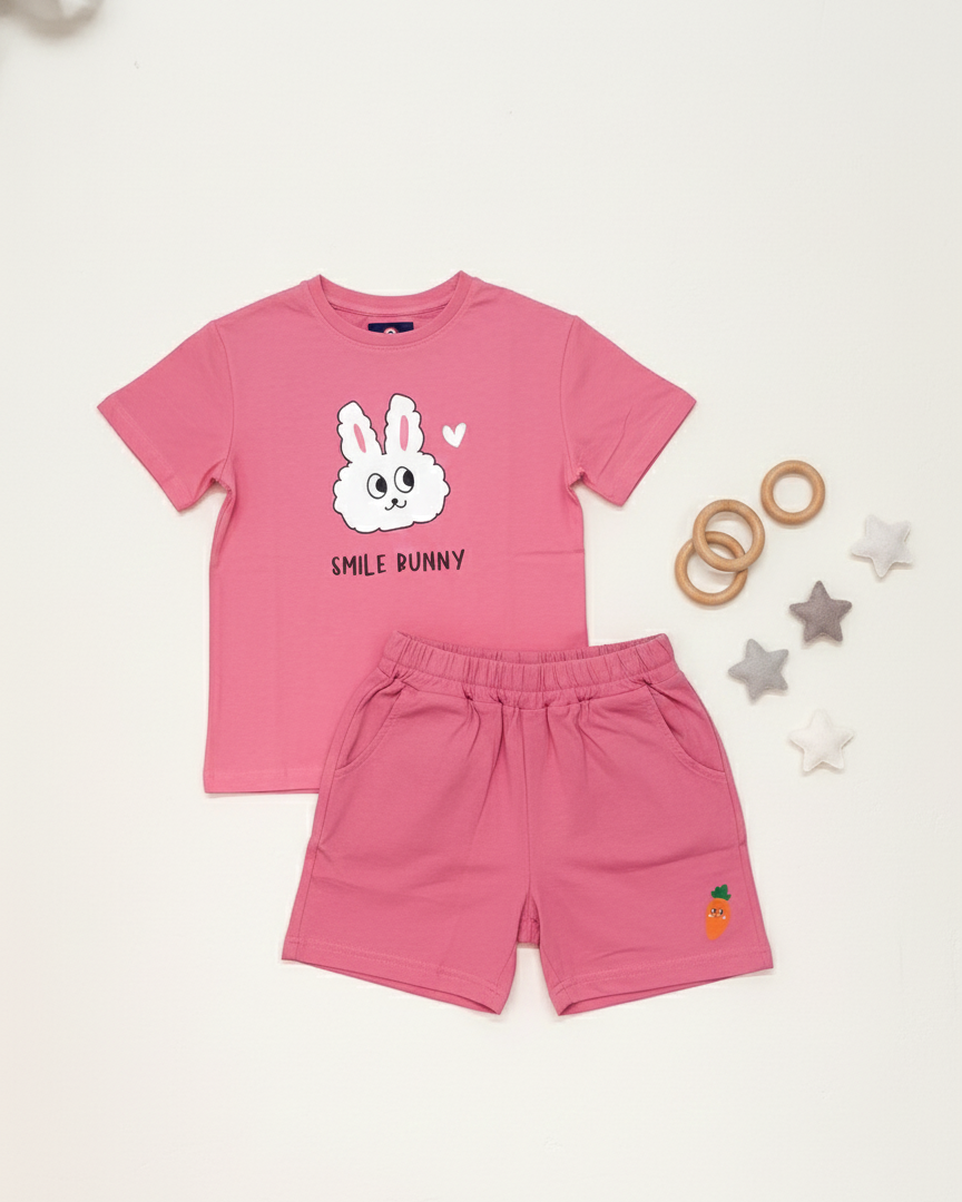 Pink children's outfit with a bunny graphic on a white background