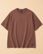 Plain Brown T-shirt placed on the Light Beige Background