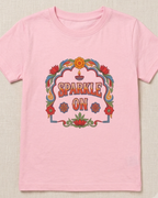 Sparkle Kids Pink T-shirt placed on the light beige background