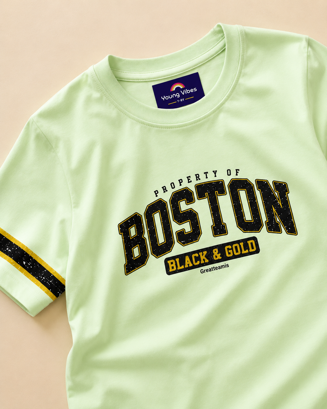 Pastel Green kids T-shirt with Boston print design placed in the light beige background closeup view of the design