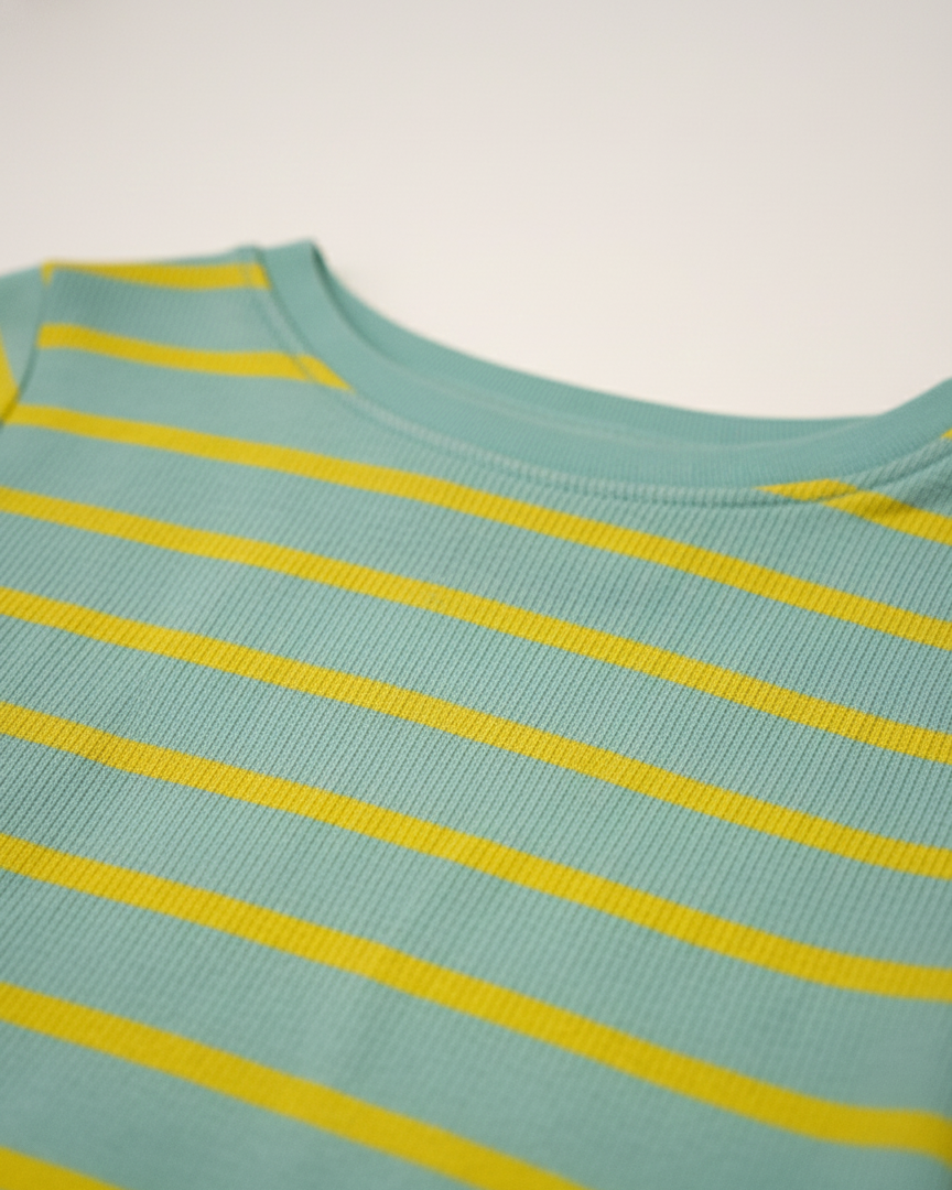 Teal tank top with yellow stripes on a light gray background