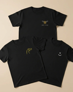 Three black t-shirts with embroidered designs on a beige background