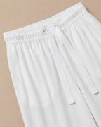 White Palazzo Pant closeup view laid on the Light beige background