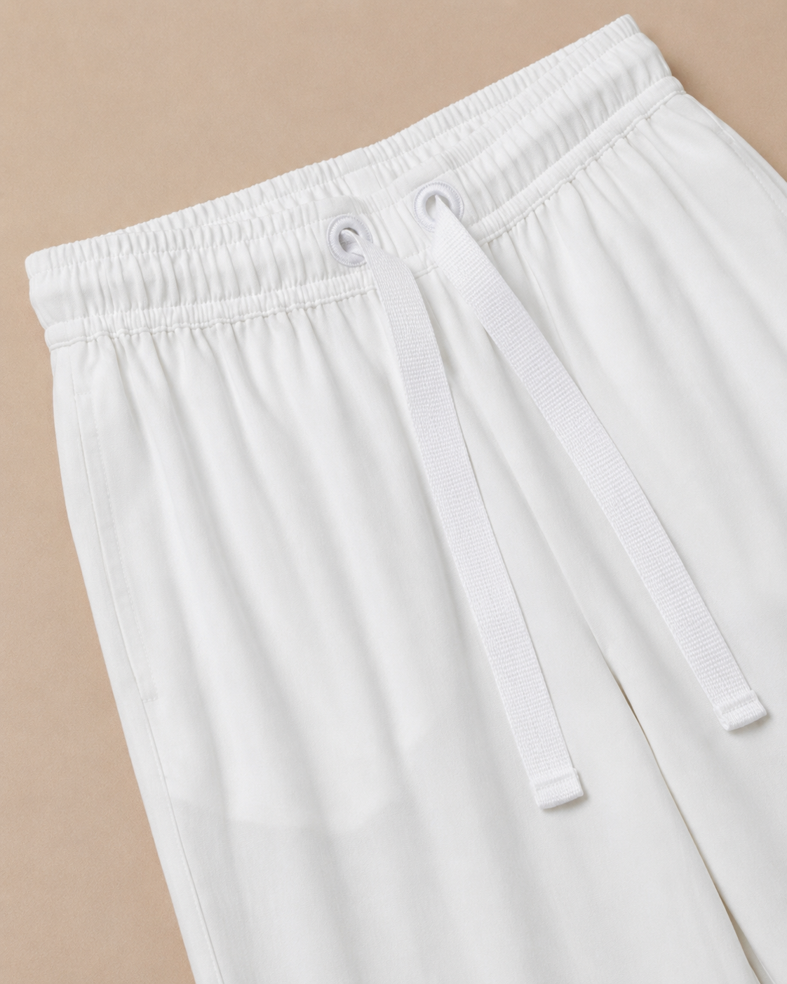 White Palazzo Pant closeup view laid on the Light beige background