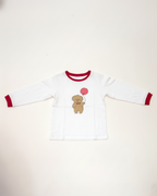 White long-sleeve shirt with red trim featuring a teddy bear design on a white background