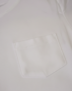 White shirt with a pocket on a light gray background