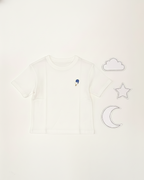 White sleeveless top with cloud, star, and moon designs on a white background