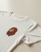 White t-shirt with a cartoon lion design on a beige background