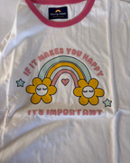 White t-shirt with a colorful rainbow and flowers graphic and text on a white background