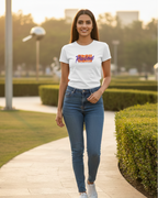 Woman walking outdoors on a path with greenery in the background
