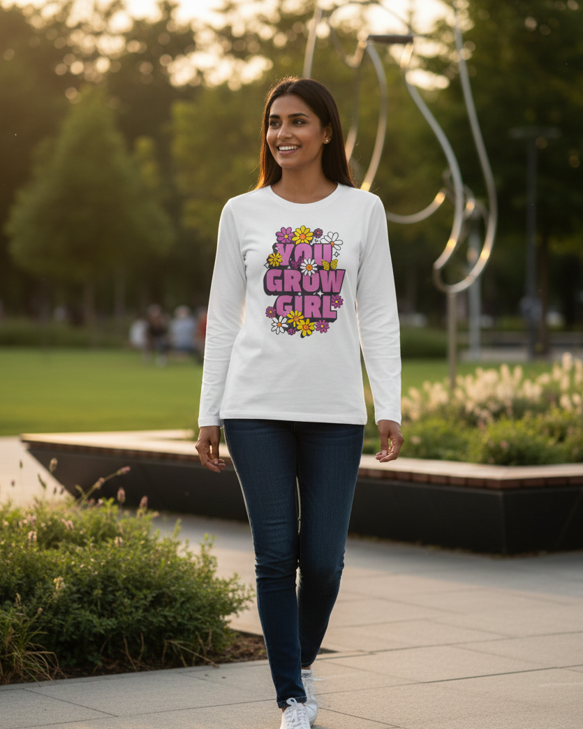 Woman walking outdoors wearing a white sweatshirt with colorful text design.