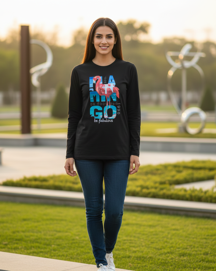 Woman wearing a black long-sleeve shirt with colorful text and graphics, standing outdoors.
