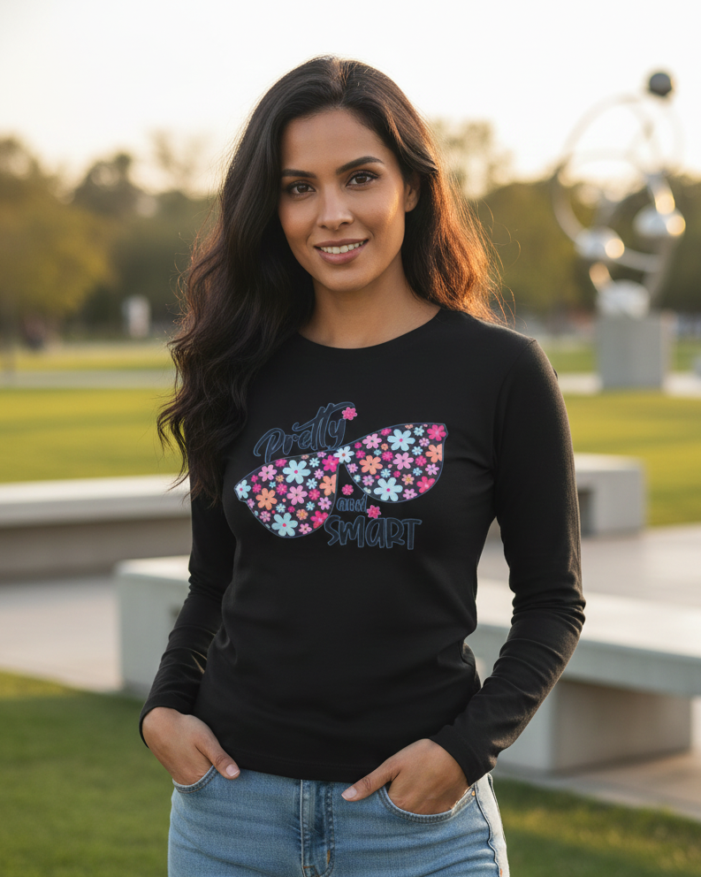 Woman wearing a black sweatshirt with colorful butterfly design outdoors