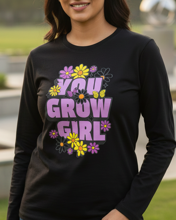 Woman wearing a black sweatshirt with colorful text in a open polite background.