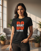 Woman wearing a black t-shirt with 'DO WHAT YOU WANT' text in a bright room.