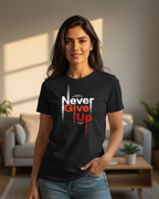 Woman wearing a black t-shirt with 'Never Give Up' text in a living room.